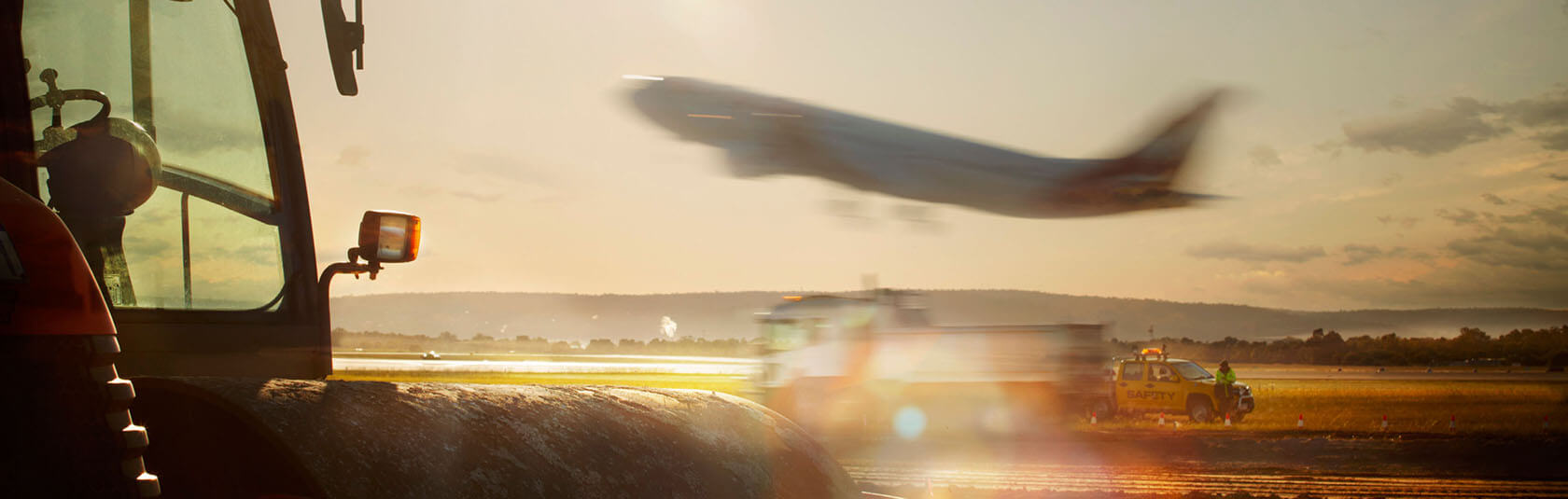 Airfield works with aircraft taking off in the background